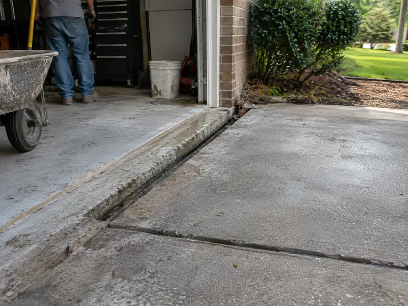 Sunken driveway panel creating a trip edge at a Baton Rouge garage