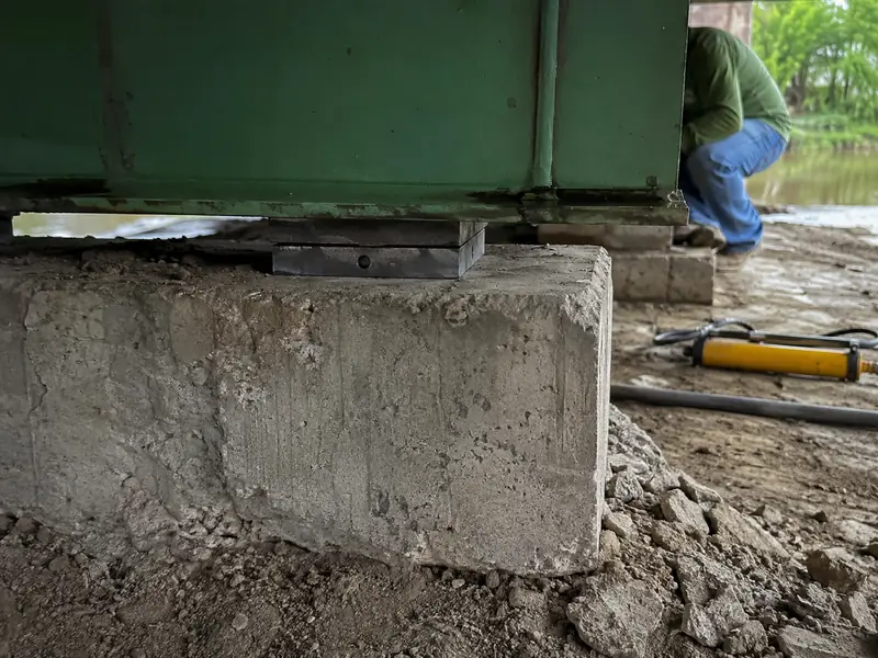 New steel shims installed on concrete pier caps after re-leveling